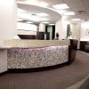 Fluid shapes of the reception desk are complimented in the ceiling details and floor covering.